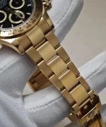 Close-up of the yellow gold bracelet details on the Rolex Daytona 126508-0004 watch.