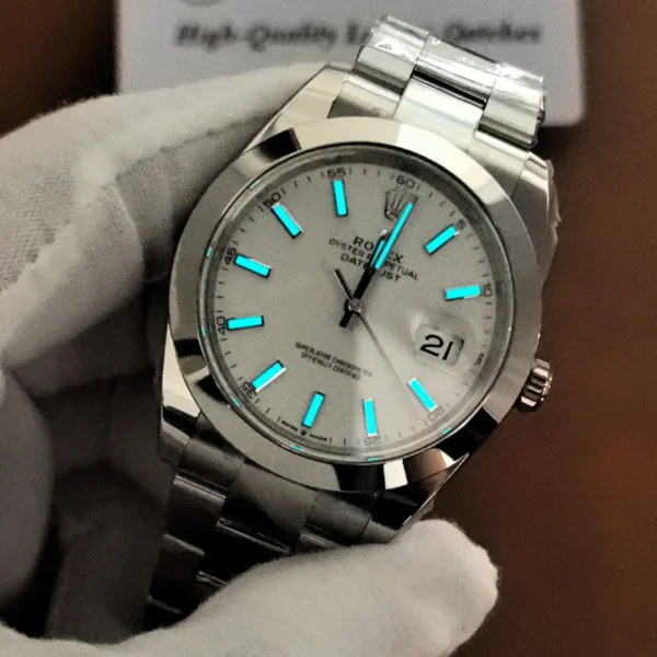 Close-up of the Rolex Datejust 41 126300 during a lume inspection, highlighting the blue glowing hour markers and hands.