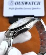 Side profile of the Rolex Datejust 126300 showing the curved polished steel case, smooth bezel, and bracelet connection.