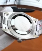 Close-up of the Rolex Datejust 126300 solid metal caseback, highlighting its circular brushed finish and finely toothed perimeter.