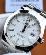 Detailed view of the Rolex Datejust 41 Ref. 126300 white dial with baton hour markers, silver-tone hands, and a magnified date window.