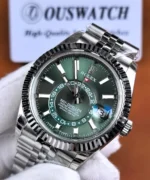 Front close-up of the Rolex Sky-Dweller 336934-0002 green sunburst dial, featuring the 24-hour indicator, applied markers, and magnified date display.